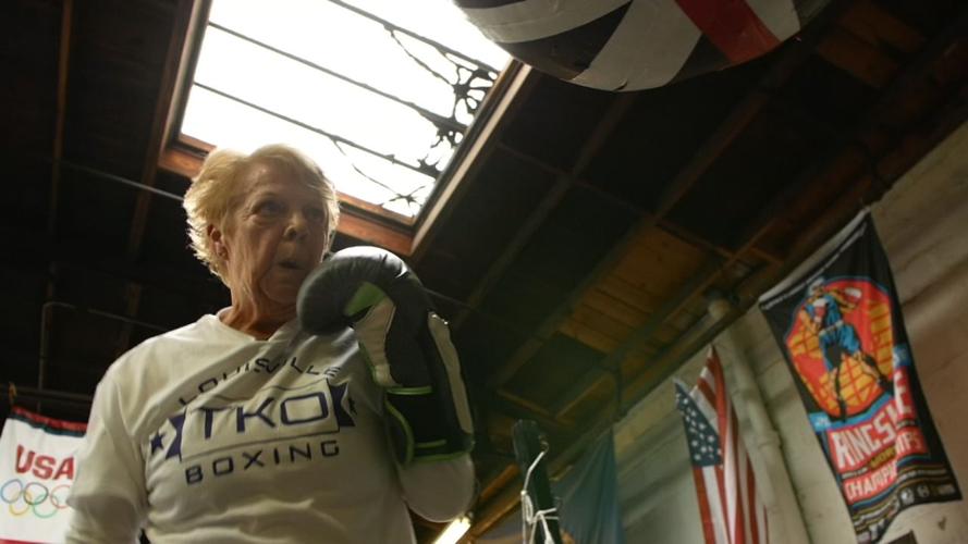 BOXING GRANDMA 5pPKG.transfer_frame_2332 punching bag.jpg