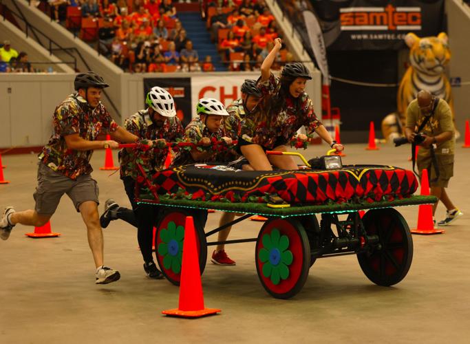 Woman cheers driving Bed Races.JPG