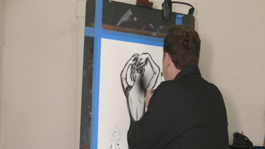 Louisville artist Grant Goodwine works on a painting