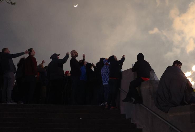 People watch fireworks from ledge.JPG