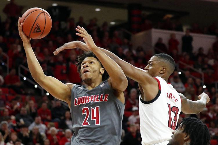 Louisville's Dwayne Sutton (24) drives the ball to the basket