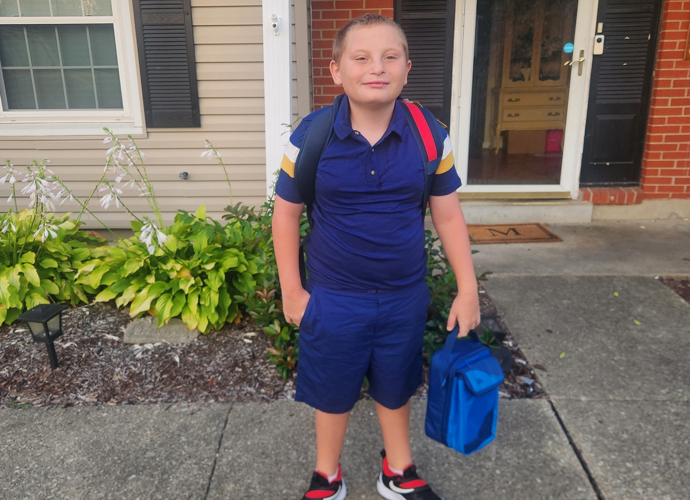 Noah Mattingly in front of home