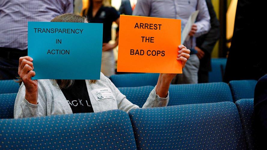 arrest the bad cops signs at presser