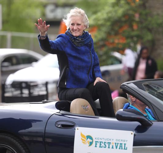 Woman waves to crowd at Pegasus Parade.JPG