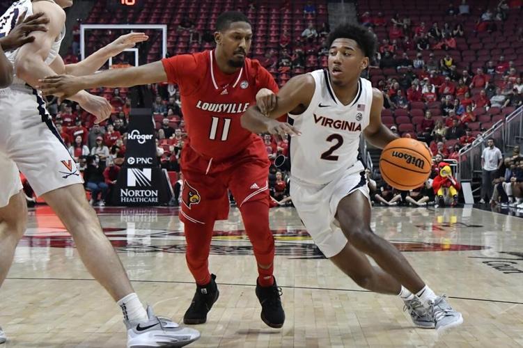 Virginia guard Reece Beekman drives around Louisville guard Mason Faulkner.jpeg