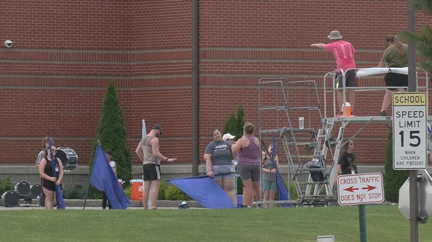 Silver Creek High band members practice near construction workers