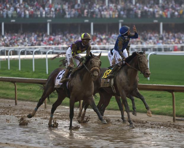 Junior Alvarado points up after winning Kentucky Derby