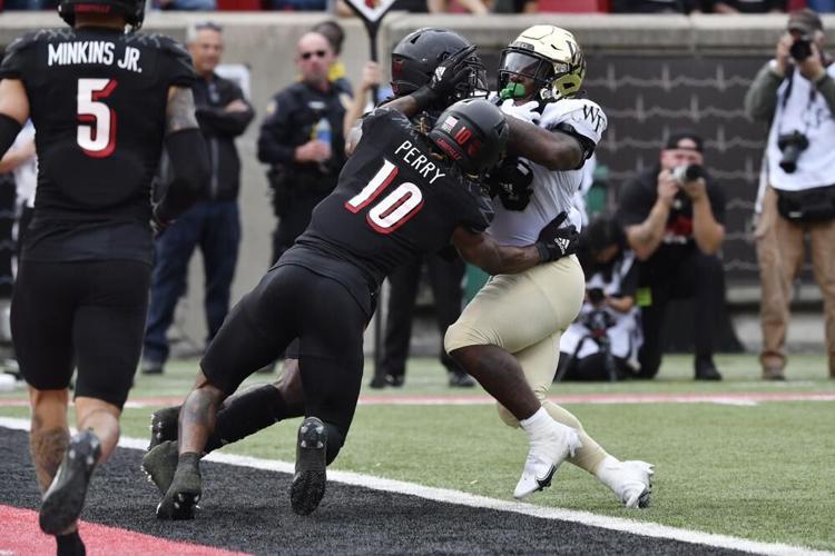 Wake Forest running back Justice Ellison is pushed back from.jpeg