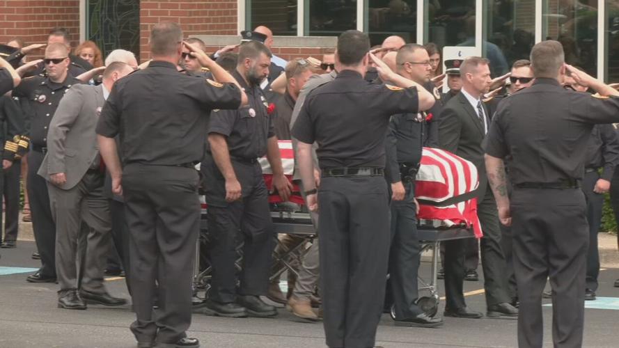 Firefighters accompany coffin of Kyle Adams