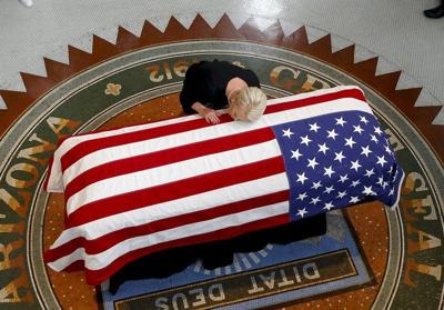 IMAGES | Sen. John McCain's family cries over flag-draped casket