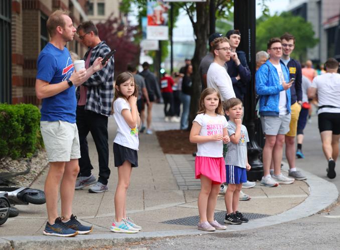 Children watch marathon runners.JPG