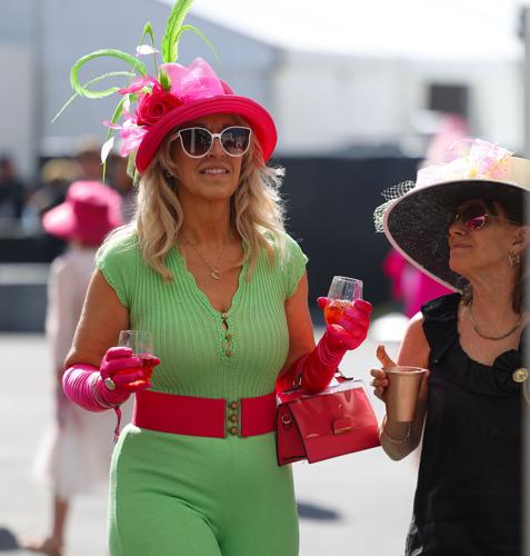 Women walk with drinks at Oaks.JPG
