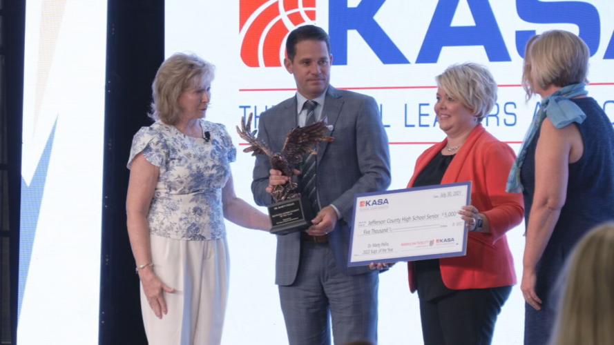 JCPS Superintendent Marty Pollio with Kentucky Teacher of the Year award