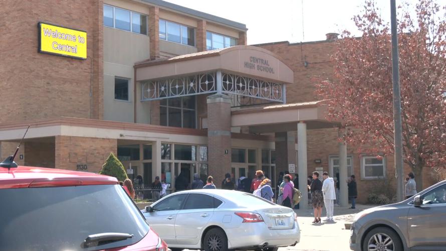 Parents wait outside Central High School during student protests on March 9, 2022