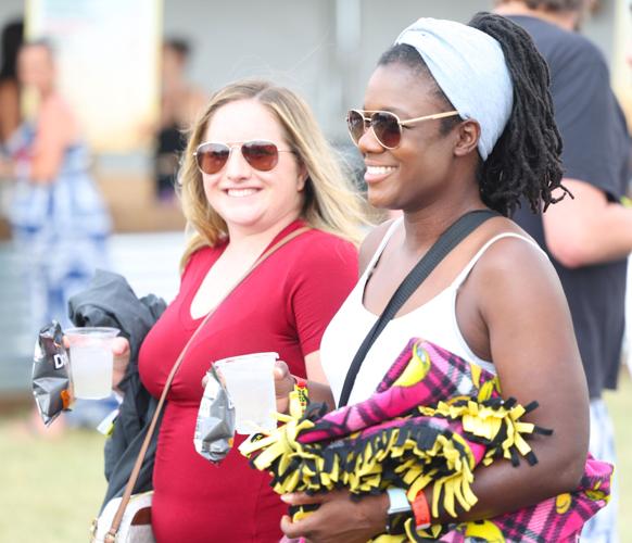 Two people smile walking toward stage.JPG