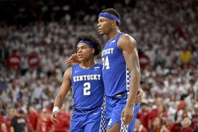 Kentucky players Sahvir Wheeler and Oscar Tshiebwe head to the bench.jpeg