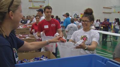 Volunteers pack thousands of meals for low-income Louisville children to eat during the summer