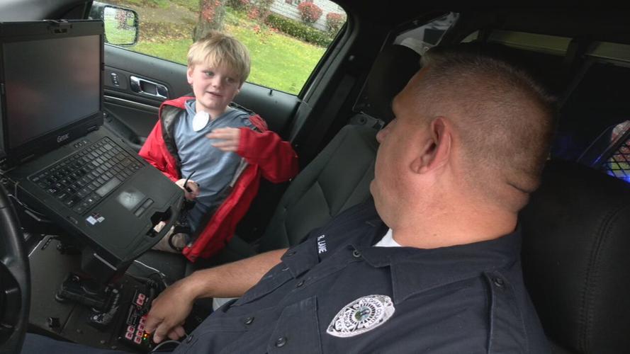 Joey Sorg and Officer Lane in police car
