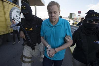 Eric Conn escorted by SWAT team agents.jpeg