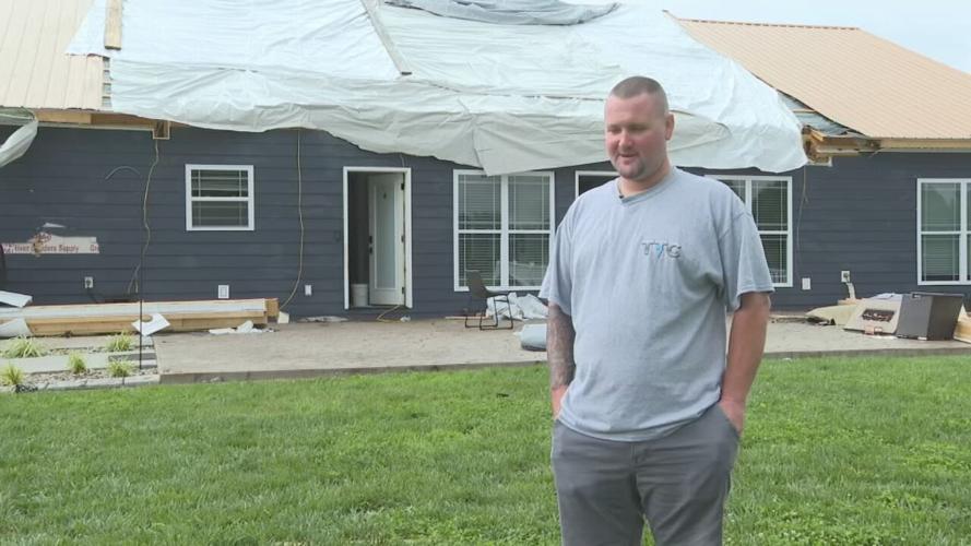 Matt Buck stands near damaged home in Casey County, Kentucky