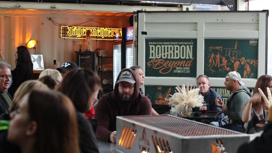 People sit outside at Taj in Louisville