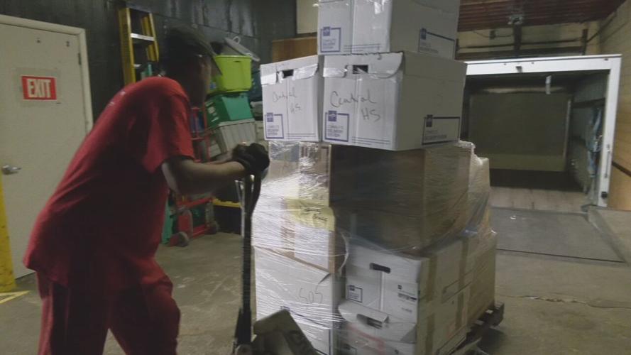 Volunteers for Louisville-based SOS pack medical supplies for JCPS students