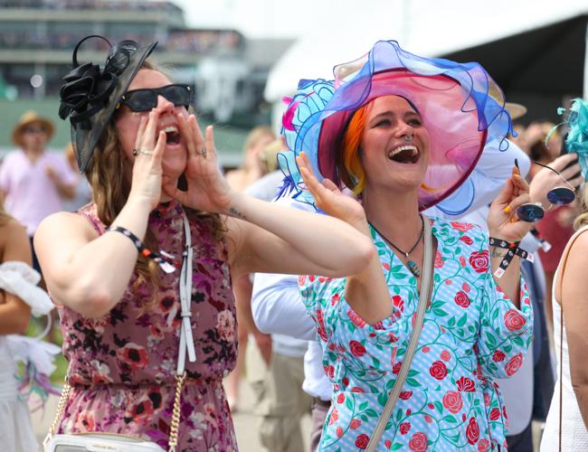 Two people cheer race in infield.JPG