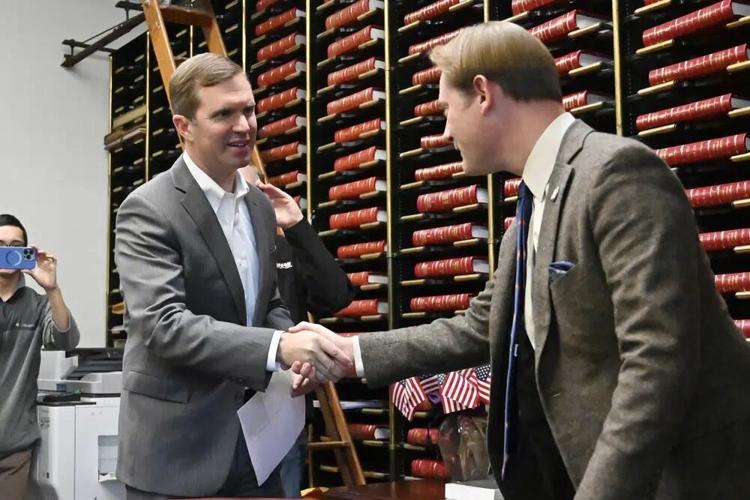 Andy Beshear shakes hands with Secretary of State Michael Adams.jpg