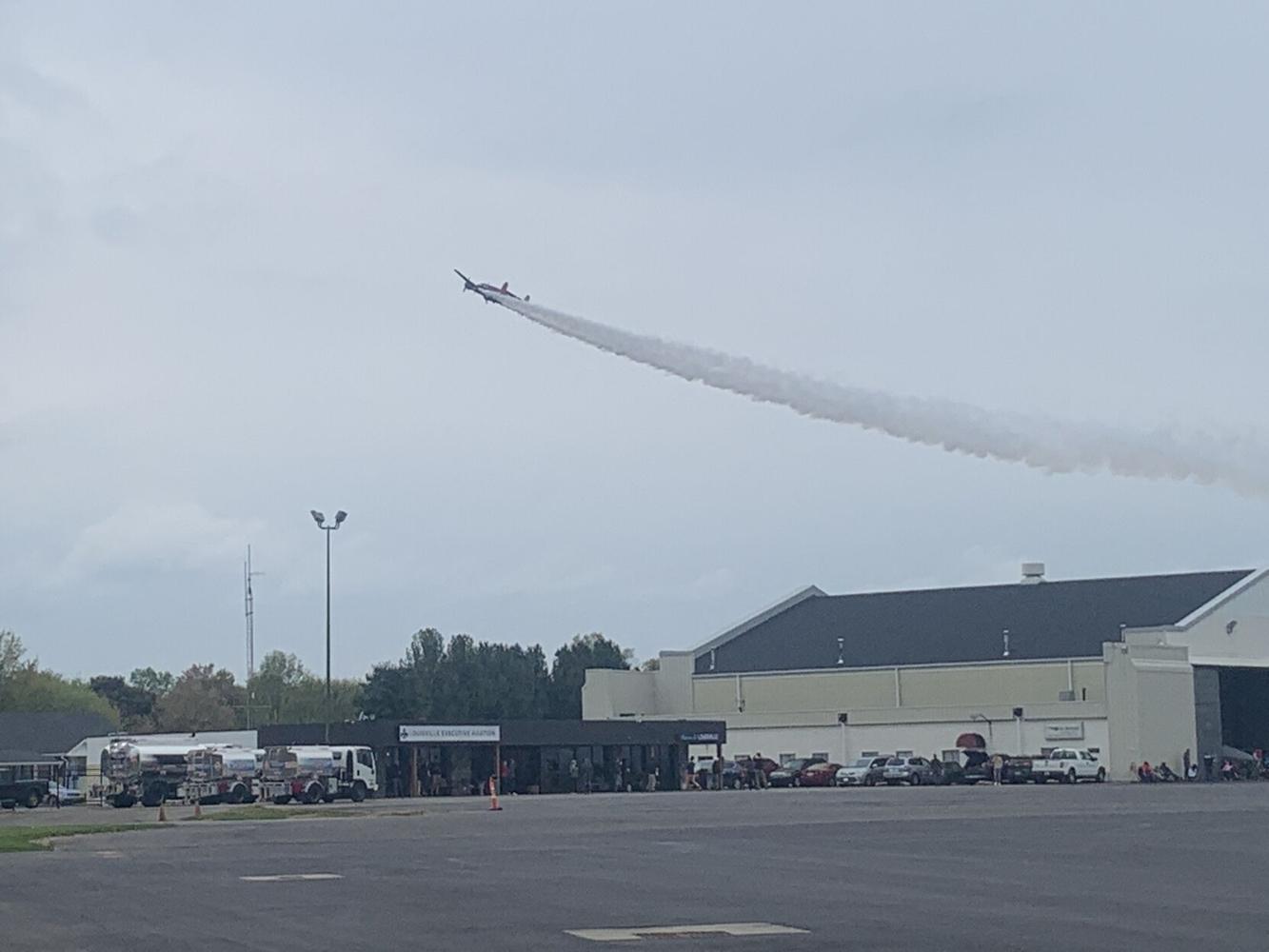A plane flies over Bowman Field during Thunder Over Louisville air show