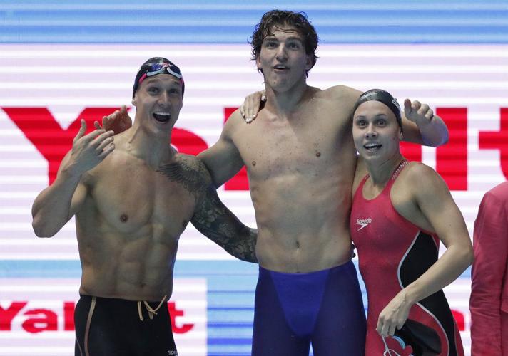 Caeleb Dressel, Zach Apple and Mallory Comerford celebrate