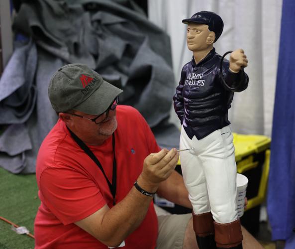 Man paints jockey figurine at Kentucky State Fair