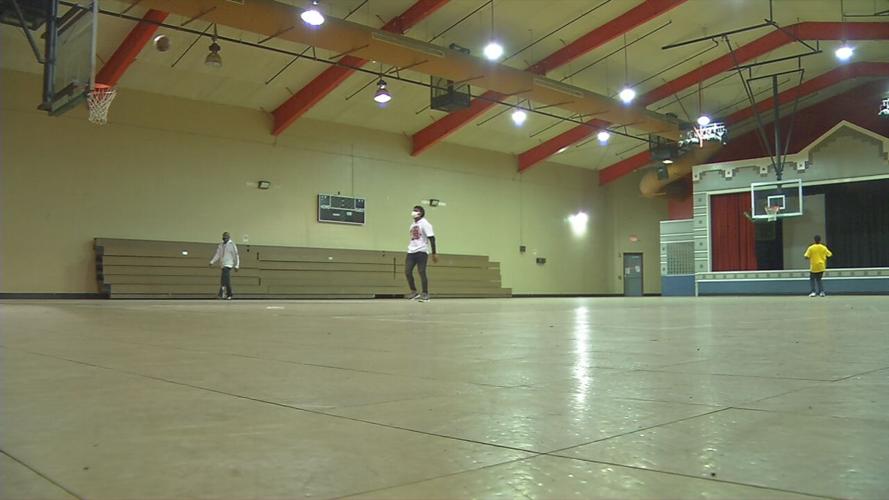 Teens play basketball at the Parkhill Community Center