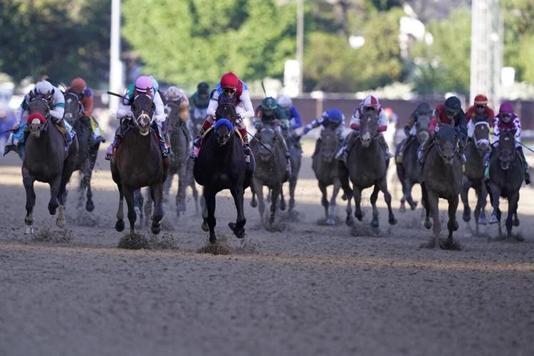 John Velazquez leads the field to win the 147th running of the Kentucky Derby