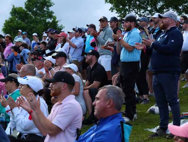 Fans cheer on 18th green