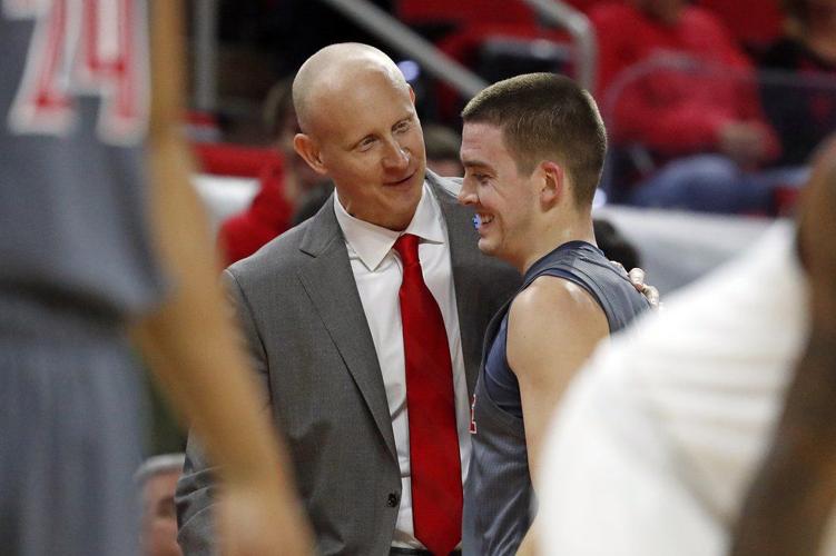 Louisville head coach Chris Mack congratulates Ryan McMahon