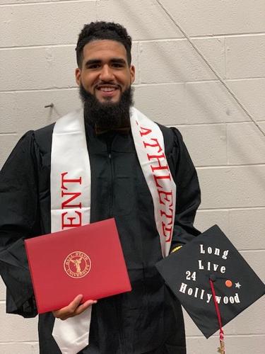Trey Moses poses with graduation cap dedicated to Zach Hollywood