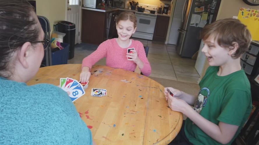 Highview family plays cards as a family activity