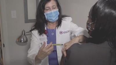 Healthcare worker gives vaccine trial