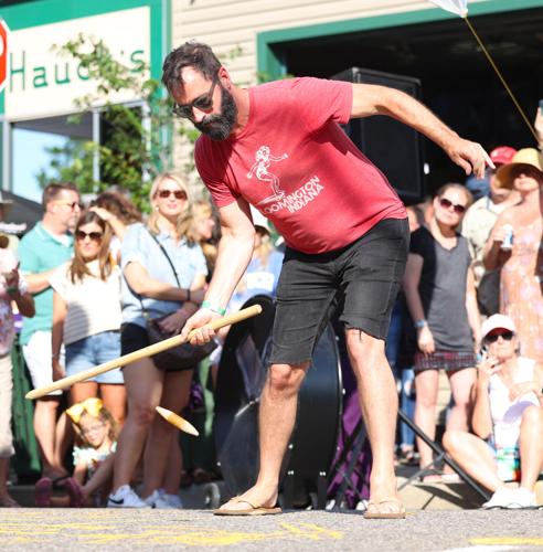 Man bends down to hit Dainty.JPG