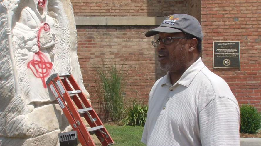 Rev. LeRoy Marshall, the pastor of Second Baptist Church, with vandalized Lucy Higgs Nichols statue.