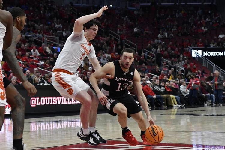 Louisville guard Jarrod West drives around Clemson forwrd Ian Schieffelin.jpeg