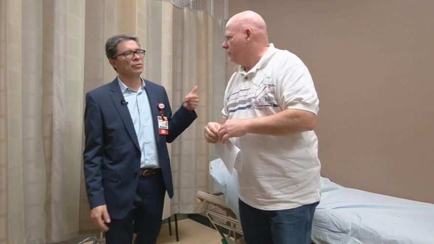 Dr. Rodrigo Moreno consults with patient Rob Easter