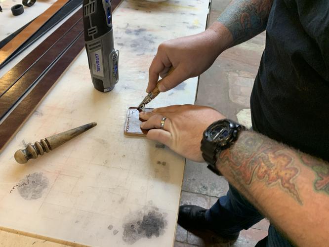 A craftsman at the Dead Sled Leather Company
