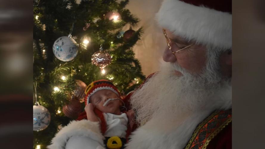 Santa Claus poses with NICU infant at UofL Health Hospital