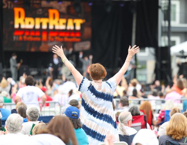 Woman raises arms at Abbey Road on the River.JPG