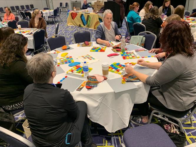 Teachers working with Braille bricks
