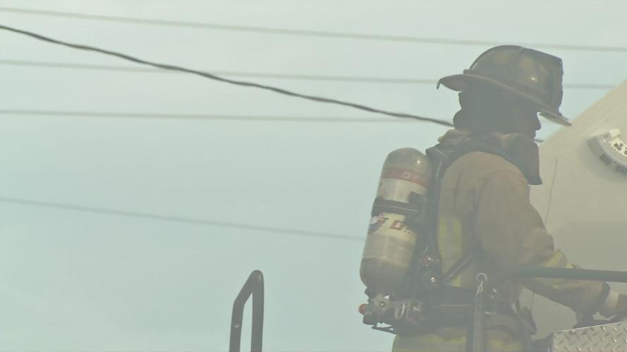 Firefighter with fire department at fire scene