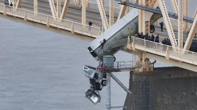 Crews rescue semi driver dangling from 2nd Street Bridge in semi cab