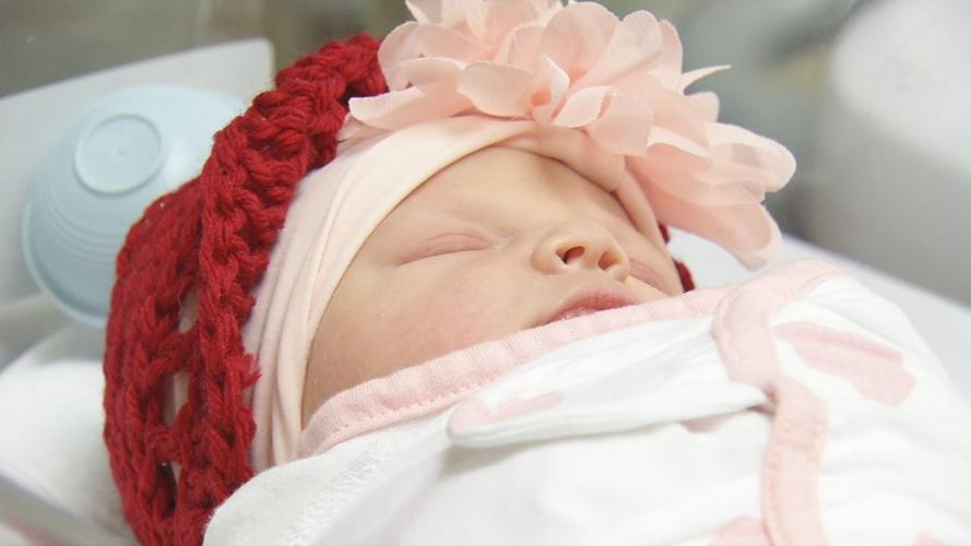 Baby in red hat for American Heart Month