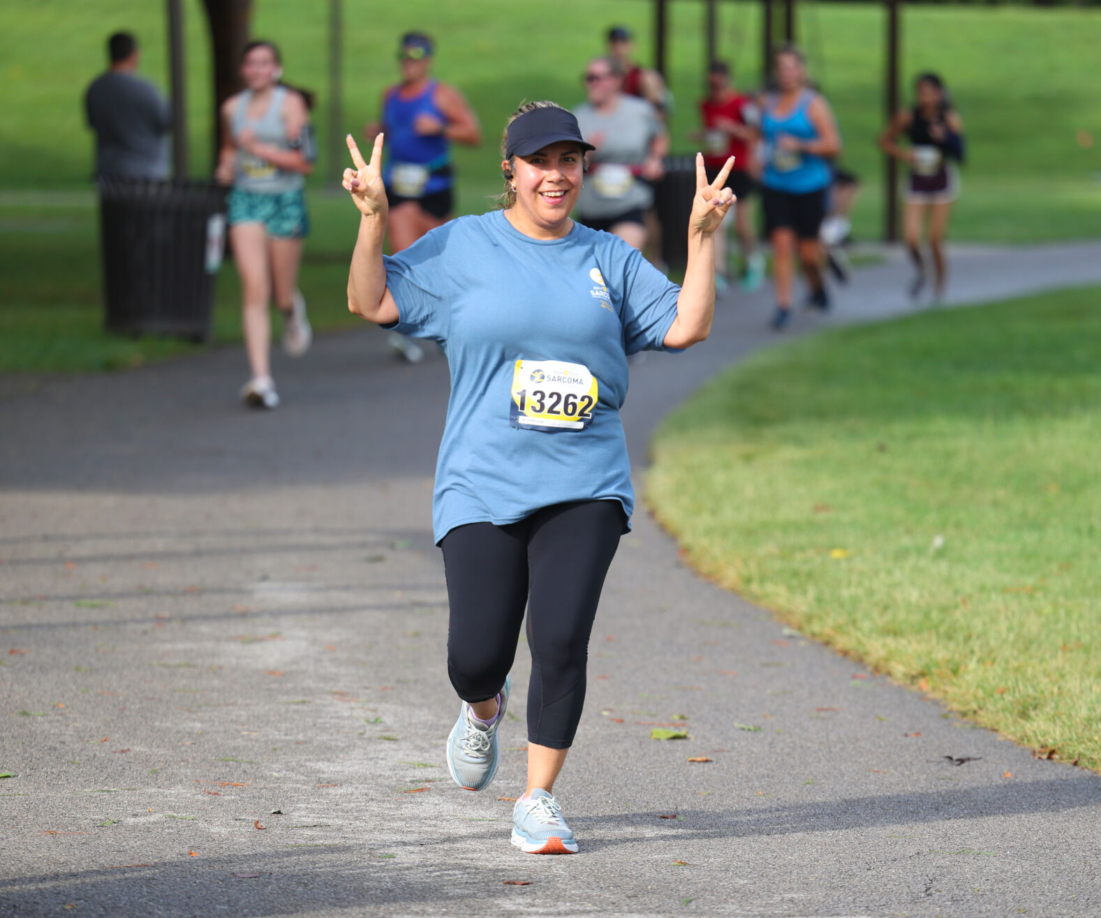 Woman raises hands at Race to Cure Sarcoma.JPG